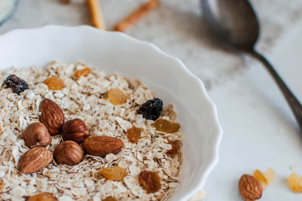 bowl of breakfast cereal with nuts and almonds