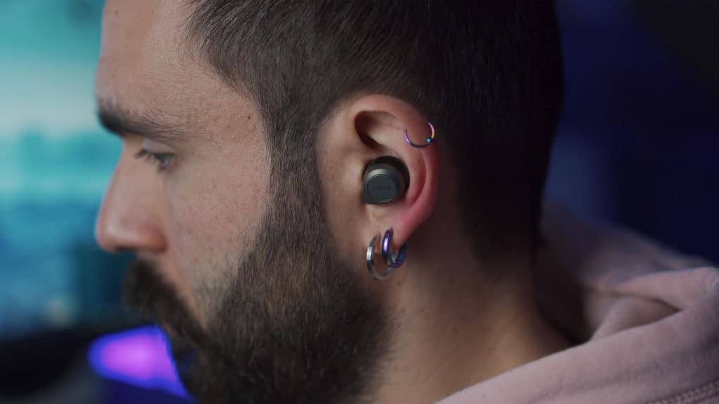 man with earphones in the ear listening to music on IEM