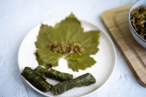 a plate of food with stuffed grape leaves