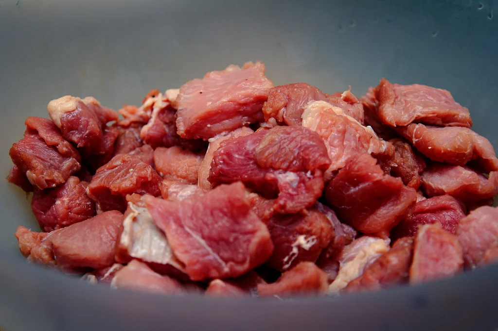 raw meat sliced in cubes in a bowl