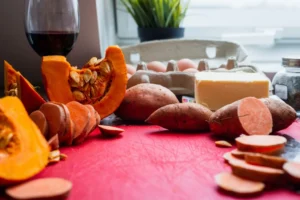sweet potatoes, pumpkin and other food on table